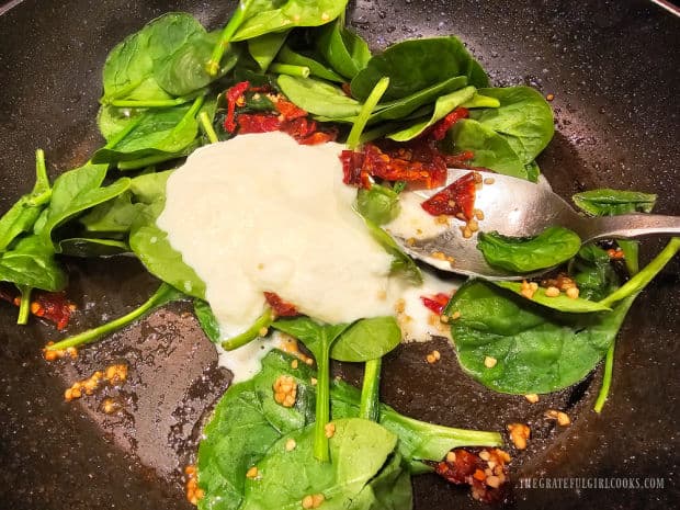 Sauce is made with garlic, whipping cream, spinach and sun-dried tomatoes.