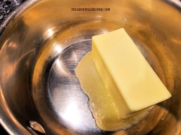 A stick of butter i melted in a medium pan.