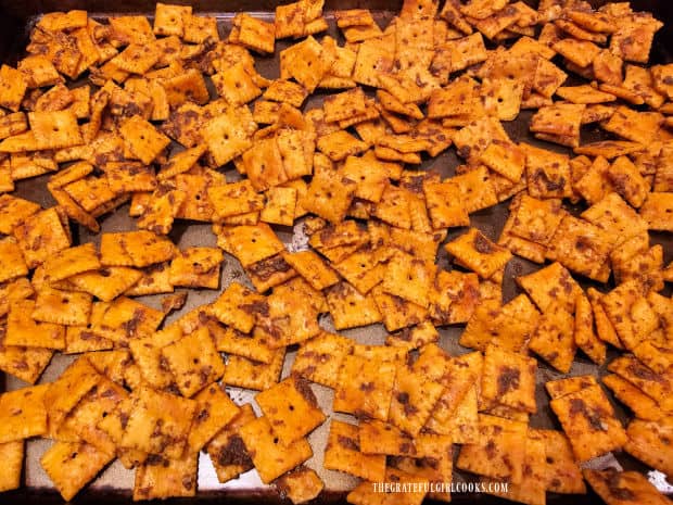 Taco-spiced cheese crackers bake in a single layer on large cookie sheet.