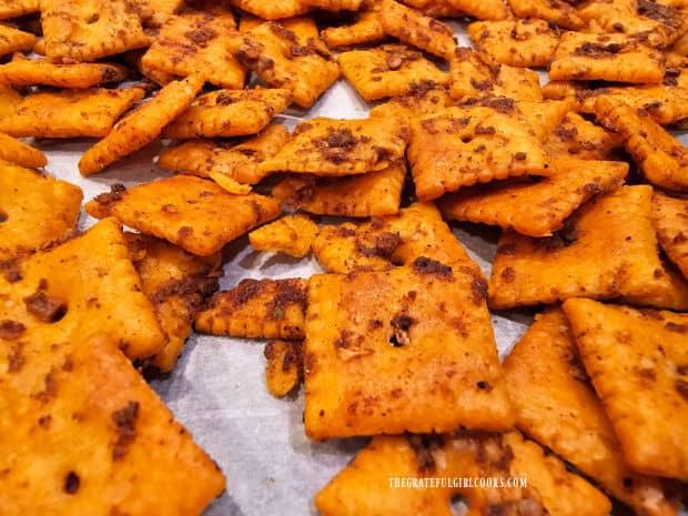 After baking, the taco-spiced cheese crackers cool on parchment paper.