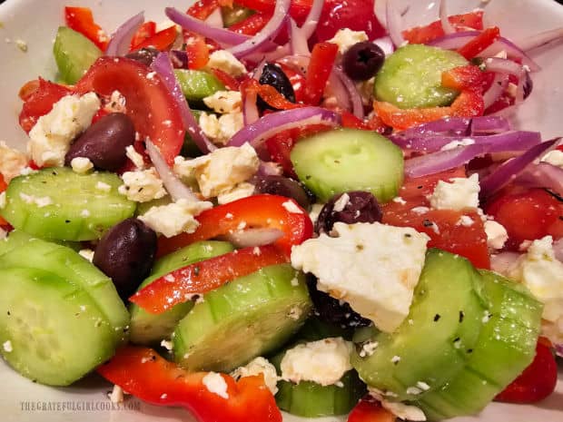 After combining the ingredients, the Greek salad is ready to be enjoyed.
