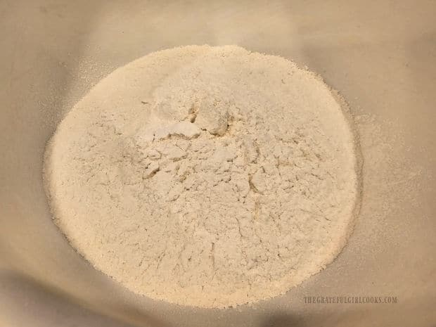 Flour, sugar, salt, baking powder and baking soda are sifted into a large bowl.