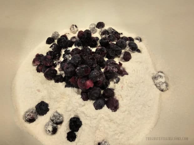 Blueberries are added to the dry ingredients for the mini-loaves of bread.