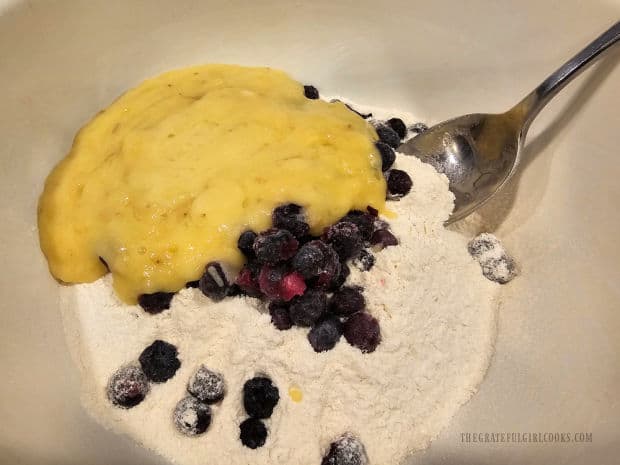 Banana mixture is added to the dry ingredients and blueberries.