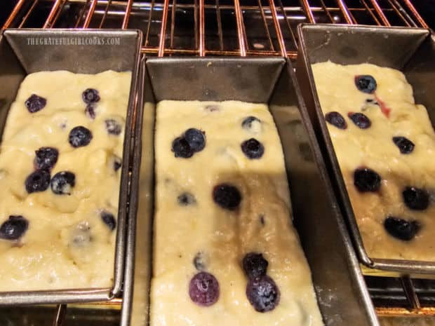 The batter for the blueberry banana bread in loaf pans in the oven.