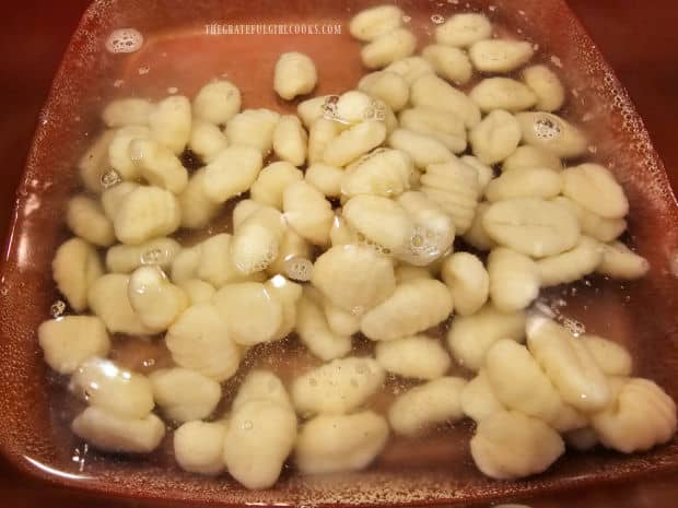 Potato gnocchi are cooked in boiling water until done.