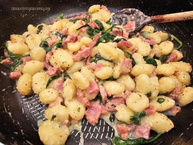 Whipping cream, Parmesan cheese and black pepper are added to gnocchi.