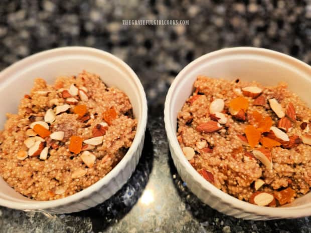 Two white bowls full of apricot almond breakfast quinoa.
