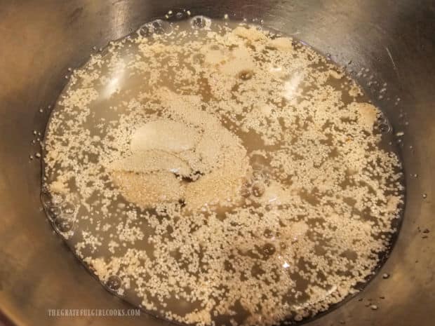 Yeast, sugar and water are combined for 5 minutes in a mixing bowl.