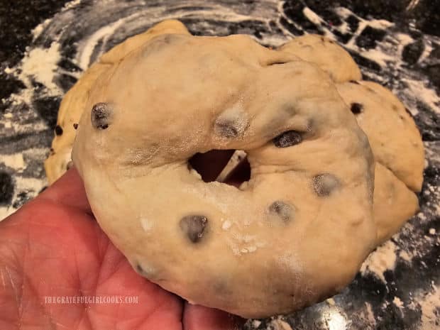 Each piece of dough is formed into a bagel shape.