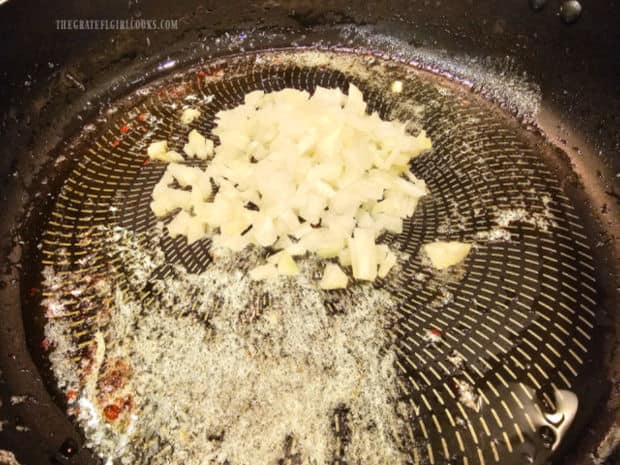 Chopped onion is cooked in bacon drippings and melted butter in skillet.