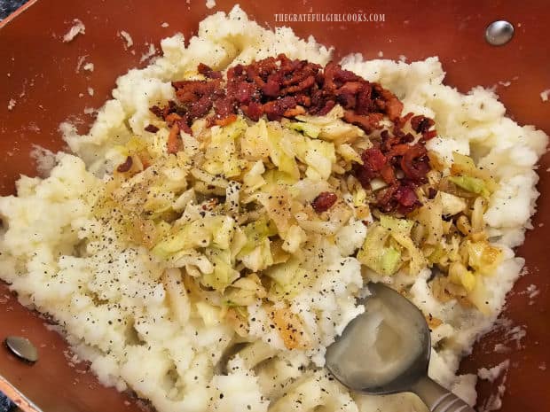 Potatoes are mashed, then cabbage, onion and bacon are added to pan.
