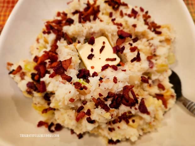 Irish colcannon with bacon is served hot with pat of butter on top.