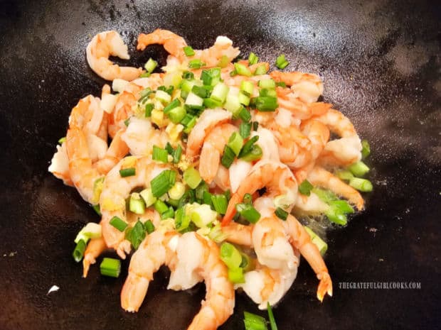 Shrimp are stir-fried with green onions, fresh ginger, and garlic.