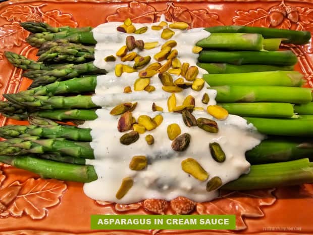 Asparagus In Cream Sauce is a simple, yet elegant side dish! Crisp-tender asparagus is topped with a lightly seasoned sauce and pistachios.