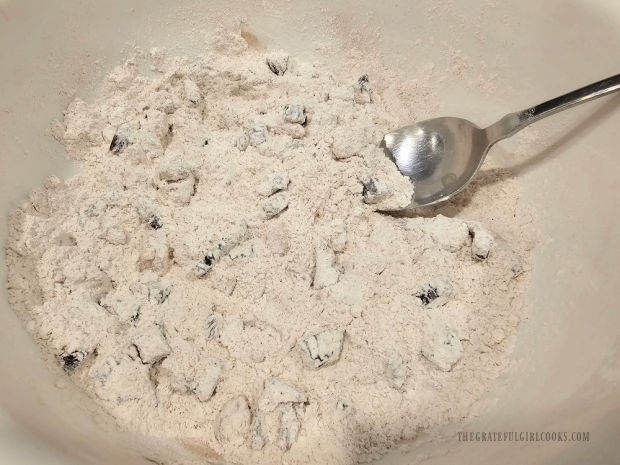 Chopped dates and apricots are coated with the flour mixture.