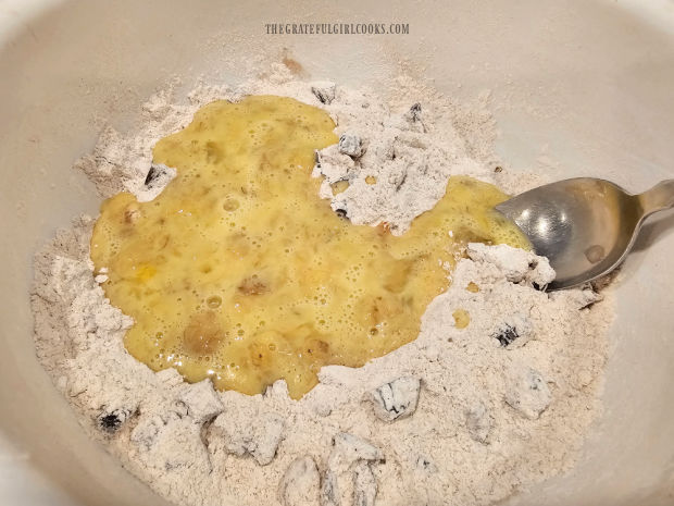 Mashed banana mixture is added to the dry ingredients for the bread.
