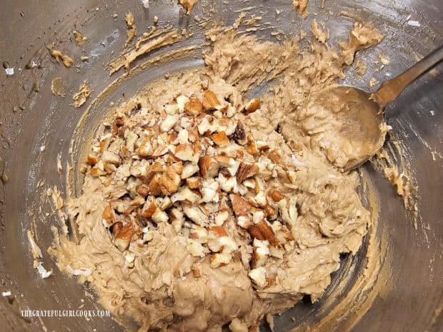Chopped pecans are stirred into the cookie dough.