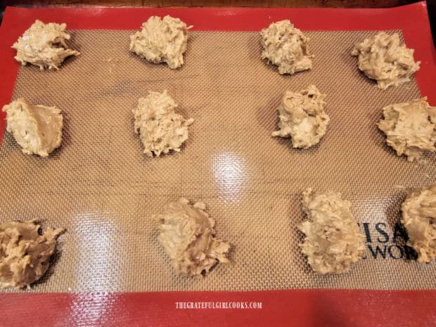 Dough is dropped onto prepared baking sheets for baking.