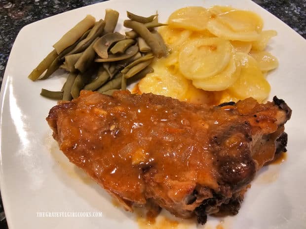 Green beans, au gratin potatoes on plate with simple savory pork chops.