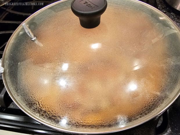 Skillet is covered, then pork chops simmer for about 25 minutes until tender.