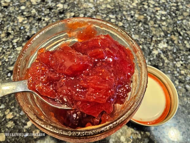 A big spoonful reveals the ruby red color of the strawberry rhubarb jam.