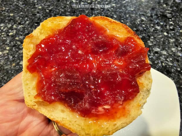 Half of an English muffin covered with the strawberry rhubarb jam.
