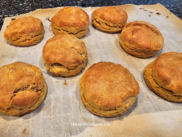 The sweet potato biscuits cool on parchment paper after baking.