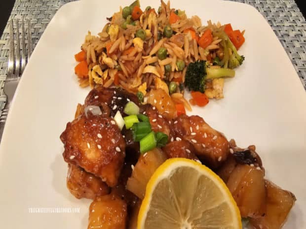 A serving of Asian Orzo Veggie Skillet on plate with lemon pineapple chicken.
