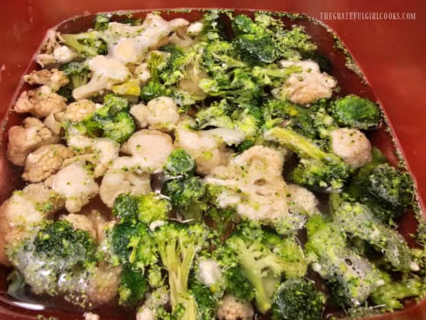Frozen cauliflower and broccoli are cooked in boiling water in pan.