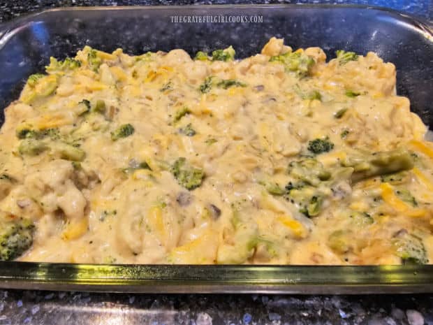 The cauliflower broccoli casserole is spread in a baking dish.