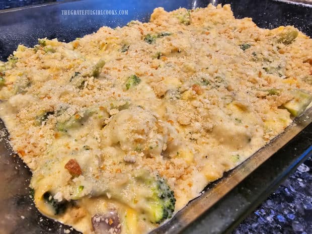 Bread crumbs are sprinkled on top of the casserole before baking.