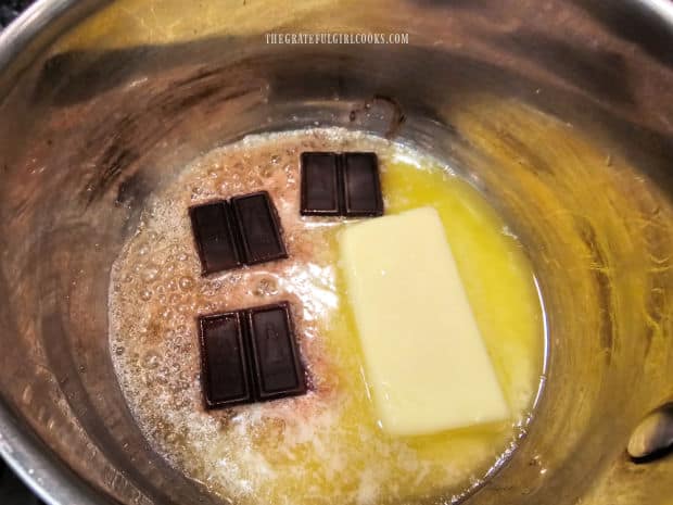 Unsweetened chocolate and butter are melted together in a small saucepan.