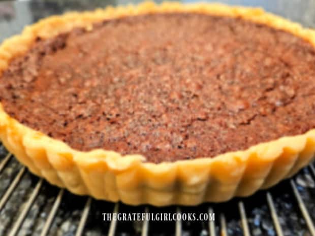 The outer tart pan ring is removed, revealing the beautiful crust.