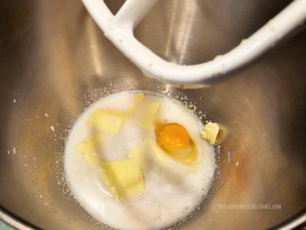 Butter, egg, and salt are mixed into yeast, sugar and milk mixture.