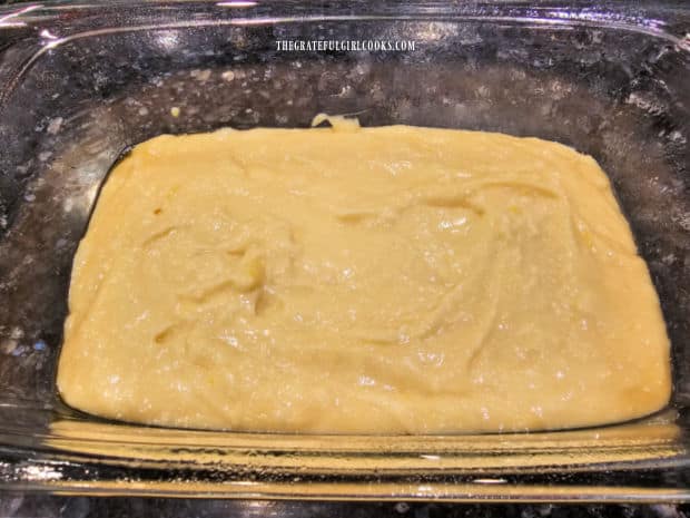 Batter for the lemon coconut loaf, in a greased loaf pan before baking.