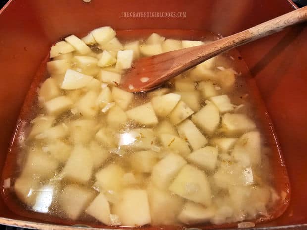 Potato chunks and water are added to pan and cooked until slightly tender.
