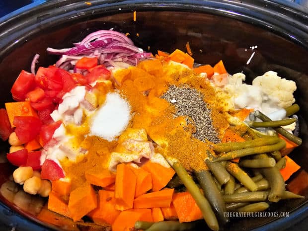Curry powder, turmeric, salt and pepper are added to the slow cooker.