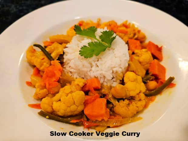Slow Cooker Veggie Curry is a meatless dish (with 7 veggies) cooked in a coconut/curry sauce. Serve with rice for a delicious, filling meal.