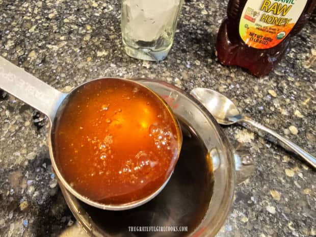 Honey is stirred into the strong, hot coffee until it has dissolved.