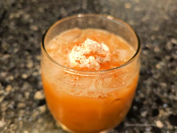 A honey almond iced latte, topped with whipped cream and cinnamon.