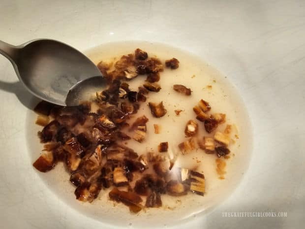 Boiling water is added to chopped dates and sugar to rehydrate the dates.