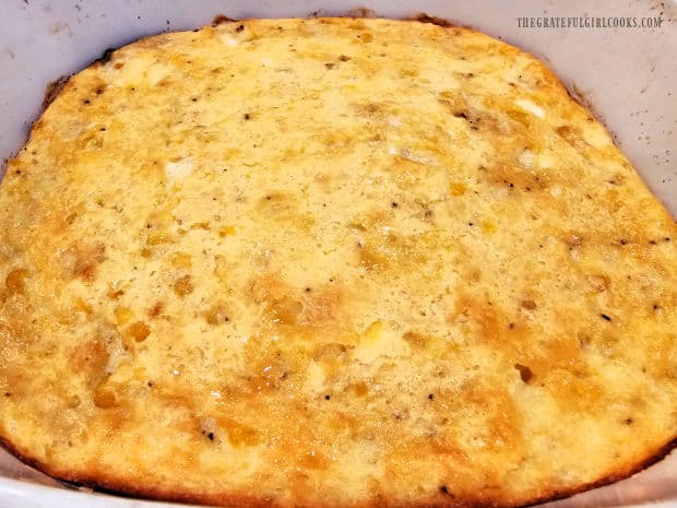 The soufflé is lightly browned and puffed after baking.