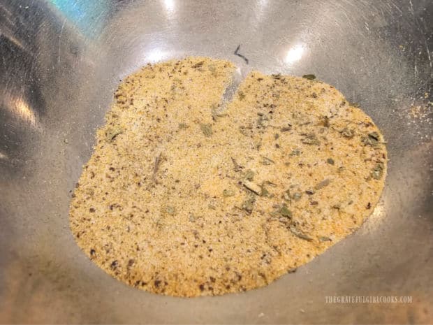 Garlic powder, salt, pepper, thyme, rosemary and tarragon are mixed.