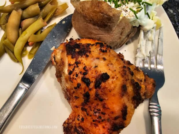 One of the chicken thighs, served with baked potato and green beans.