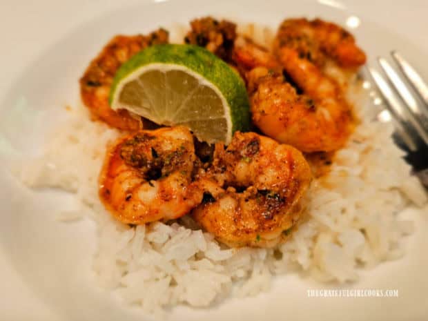Lime Brown Butter Shrimp is served with a lime slice on top of white rice.