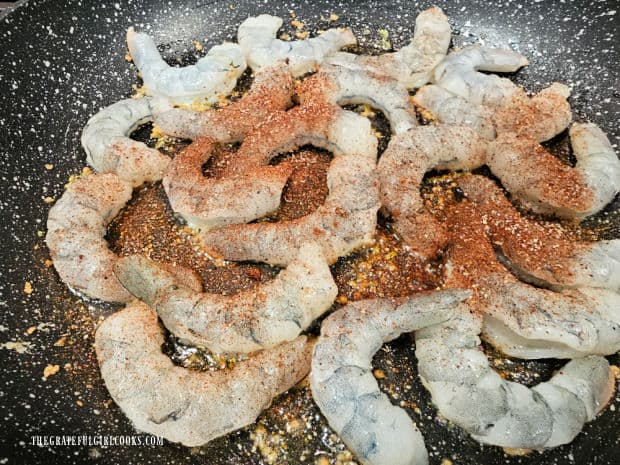 Chili powder, cumin, salt and pepper are added and stirred into the shrimp.