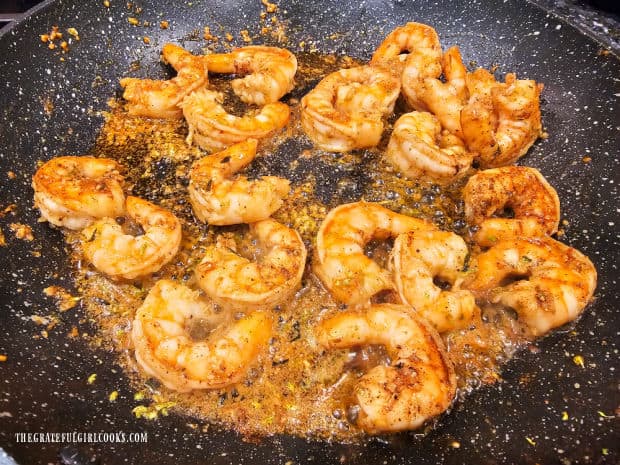 Remaining brown butter lime sauce is added back into the skillet of shrimp.