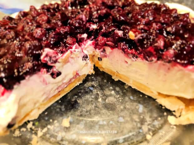 After chilling for several hours, the blueberry banana cream cheese pie is sliced for serving.