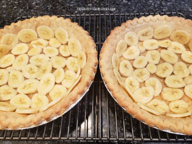 Thin banana slices are used to line the bottom and sides of the pie crusts.